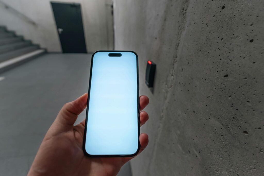 A smartphone unlocking a secure door using NFC technology in a modern building stairwell.